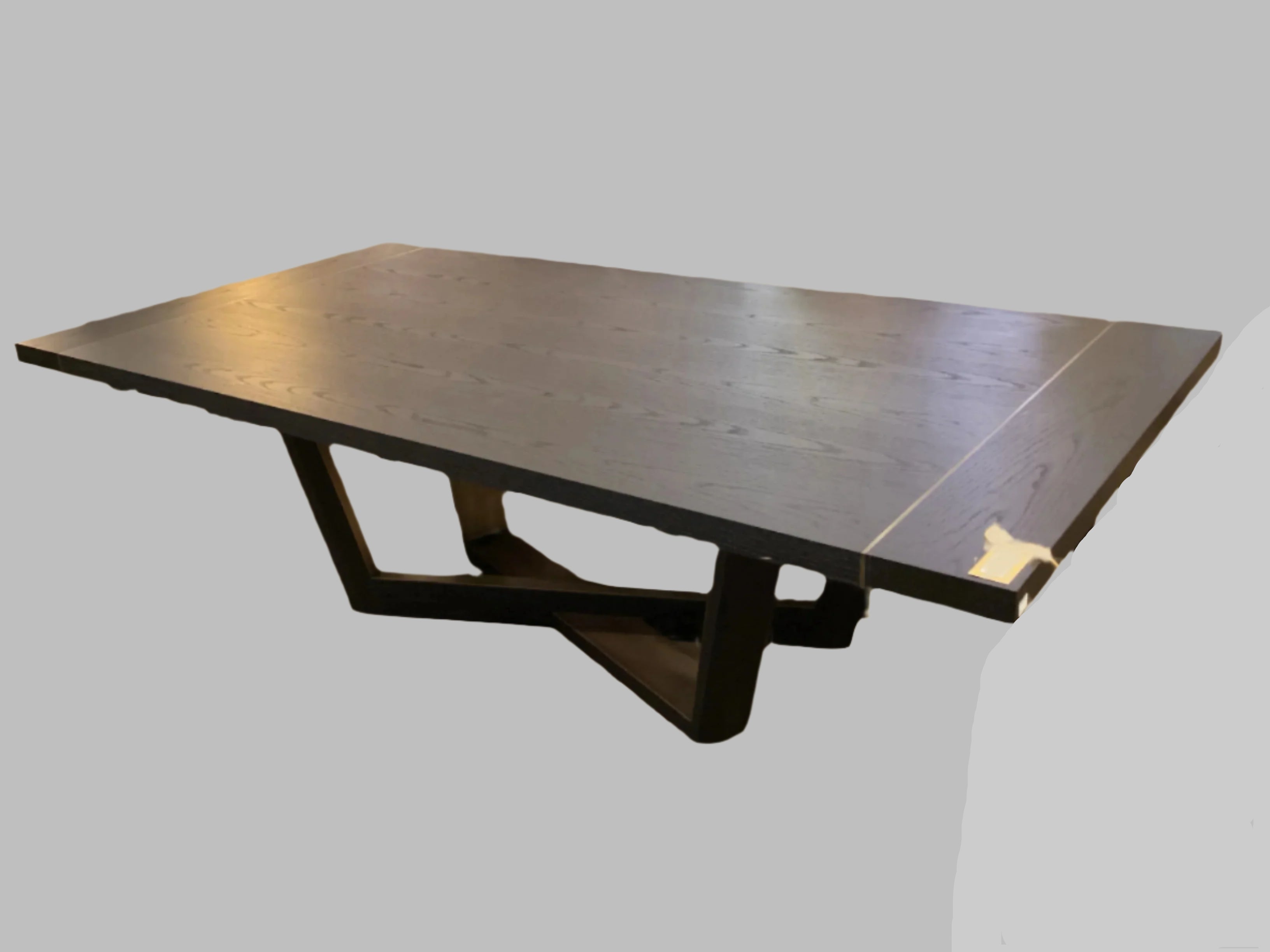 Large dark wooden dining table with four matching chairs on a plain background