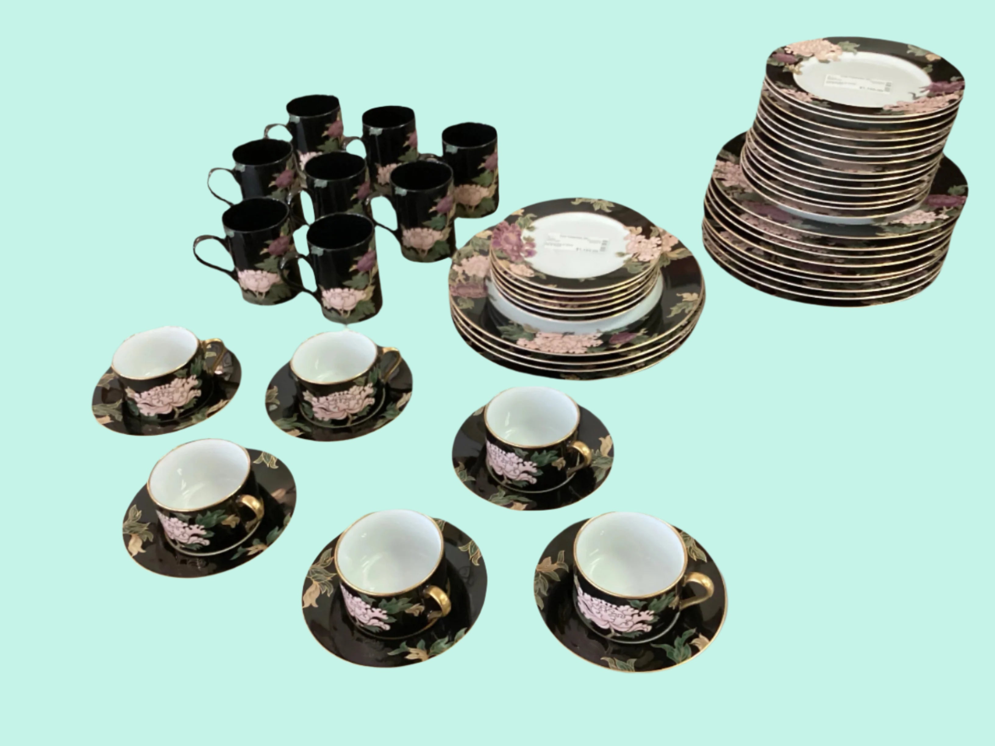 Ceramic dinnerware set with floral patterns on a light blue background