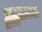 Gray sectional sofa with cushions on a beige background