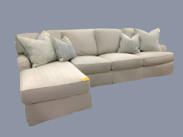 Gray sectional sofa with cushions on a beige background