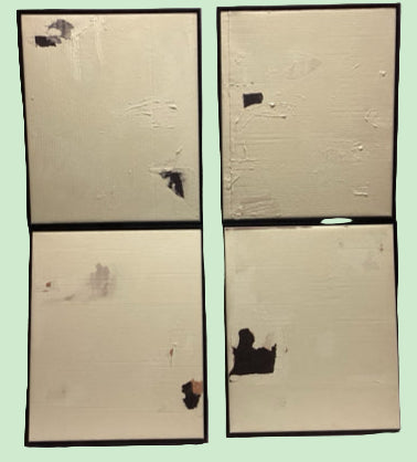 Four square panels with black ink blots 